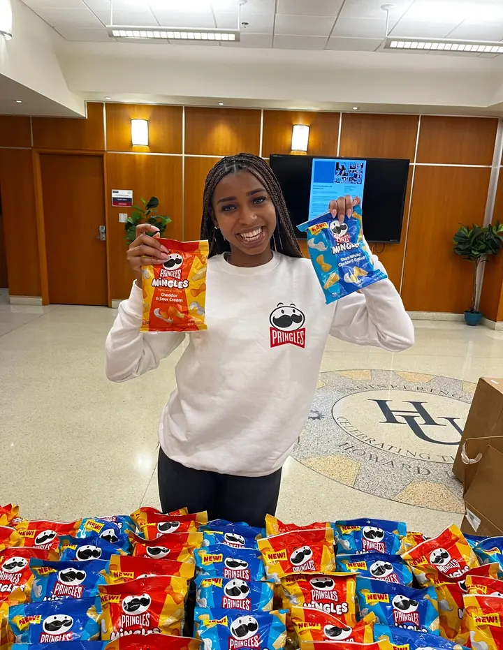 EvolveZ student Brand Ambassador distributing snack product samples on a college campus